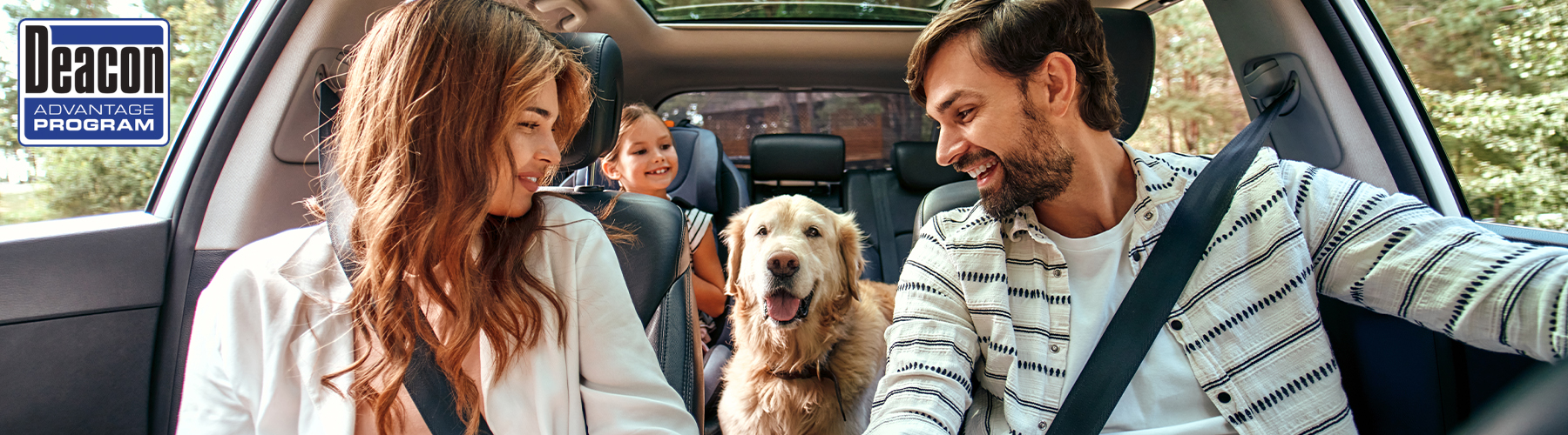 The whole family is driving for the weekend. Mom and Dad with their daughter and a Labrador dog are sitting in the car.