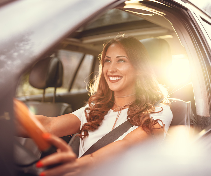 Happy woman driving her vehicle