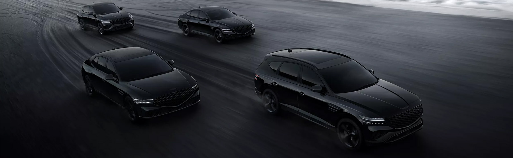 2026 Genesis G90, G80, GV80, and GV80 Coupe Prestige Black vehicles driving along beach shoreline