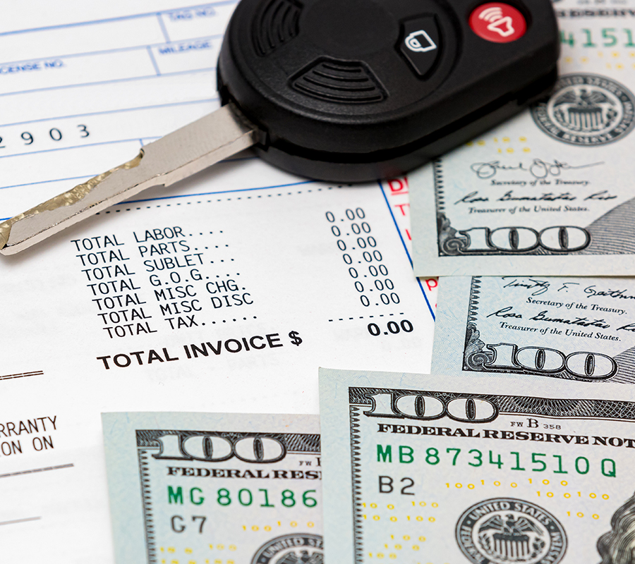 Car key, vehicle warranty repair bill and 100 dollar bills cash. Concept of vehicle manufacturer extended warranty. Automobile maintenance and service costs