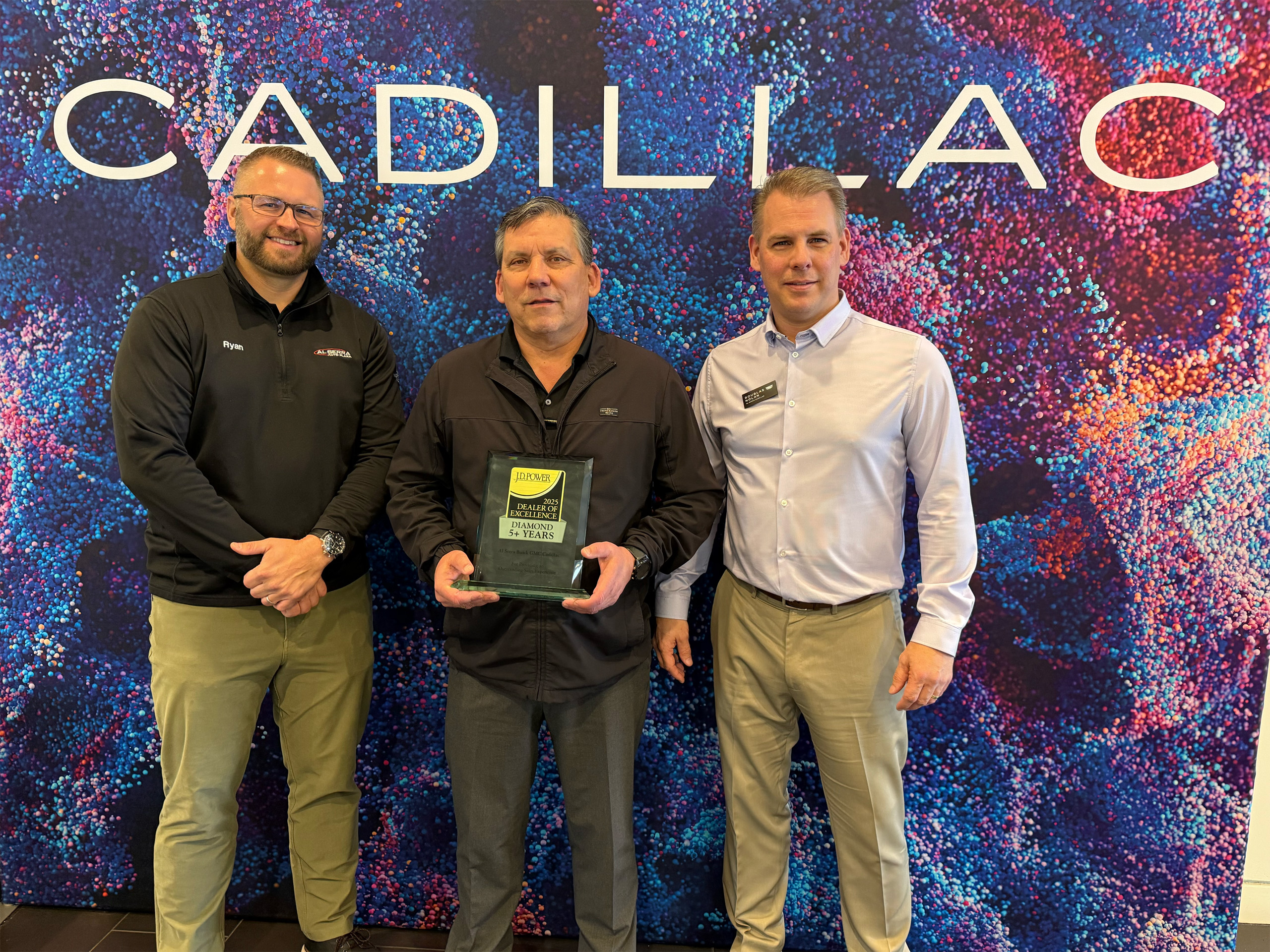 Dealership employees holding JD Power Award