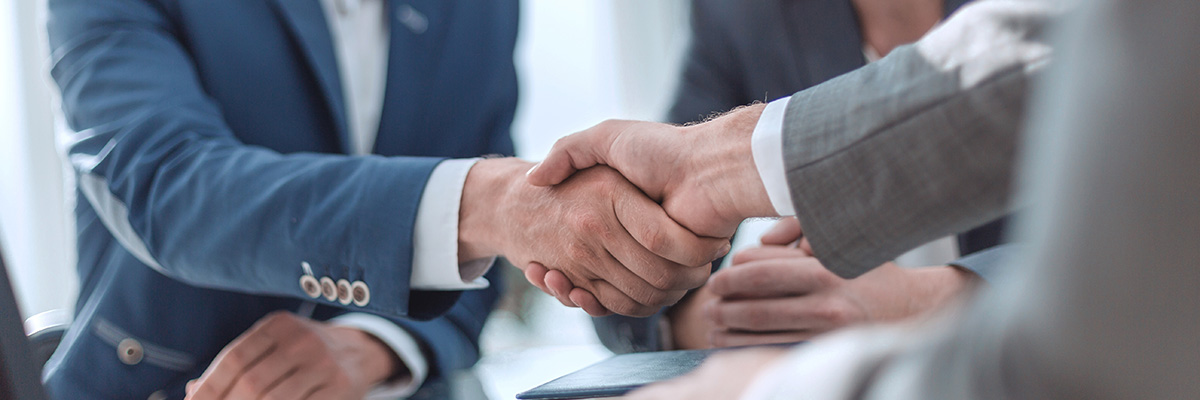 Up close shot of customer shaking businessmans hand