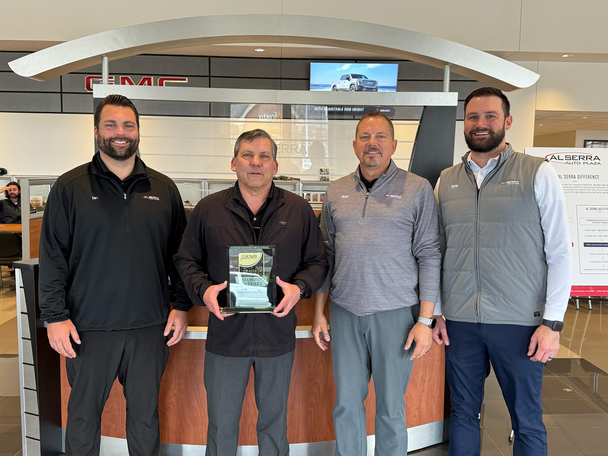 Dealership employees holding JD Power Award