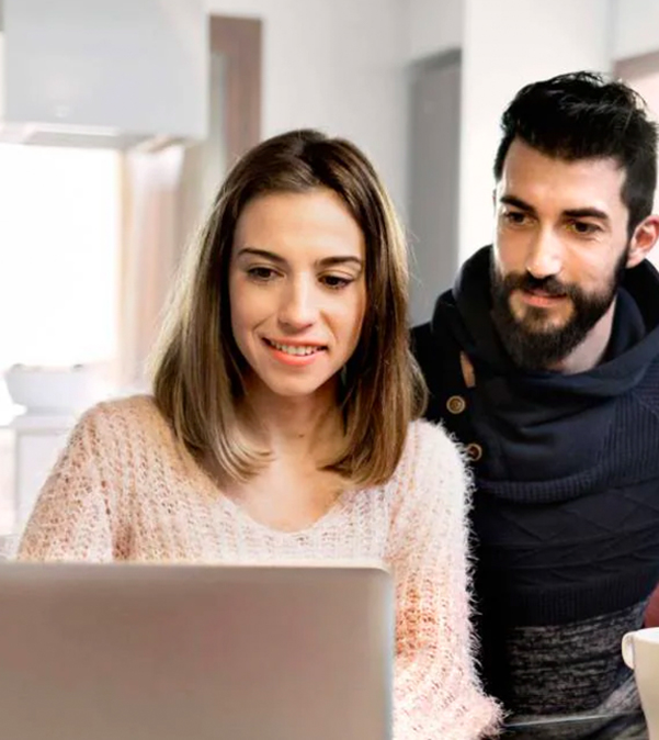 Couple looking at Nissan vehicle inventory online at home