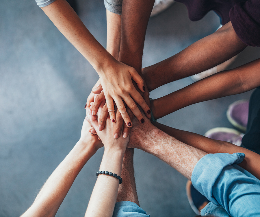 Stack of hands showing unity and teamwork