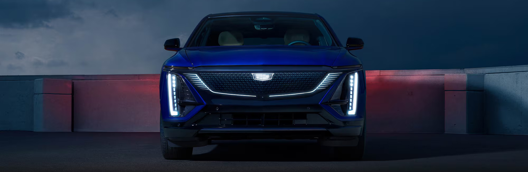 Front View of a Blue Cadillac LYRIQ Parked at Night