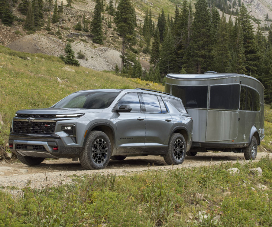 A 2027 Chevy Traverse Parked With a Trailer Attached in an Outdoor Setting.