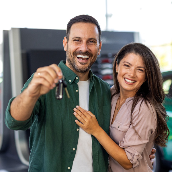 Customers smiling holding car keys